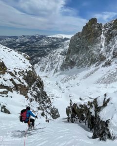 Ski mountaineer jump turns down a couloir in Rocky Mountain National Park.