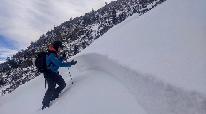 Avalanche educator teaches under an avalanche crown in Rocky Mountain National Park.
