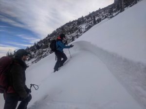 Avalanche educator teaches below an avalanche crown in Rocky Mountain National Park.