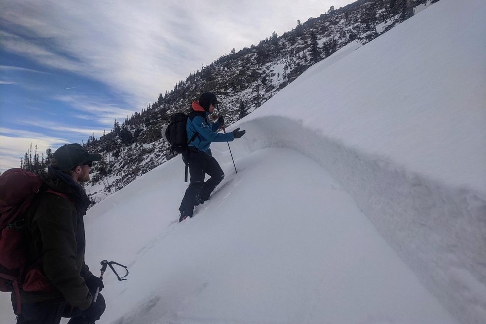 Avalanche educator teaches below an avalanche crown in Rocky Mountain National Park.