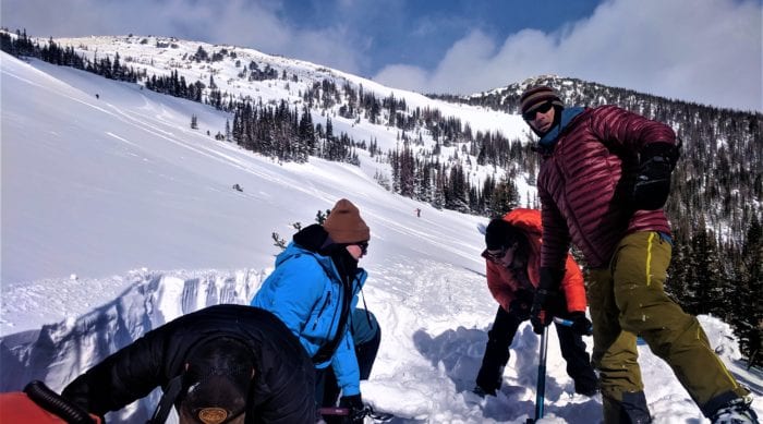 a group of backcountry riders learning the basic of snow science