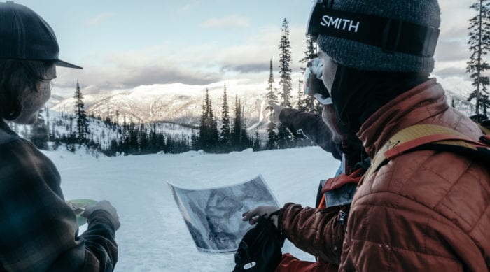 backcountry skiers checking a map