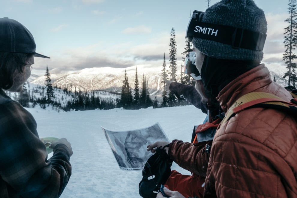 backcountry skiers checking a map