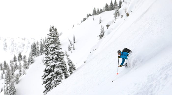 backcountry skier taking waist deep turns