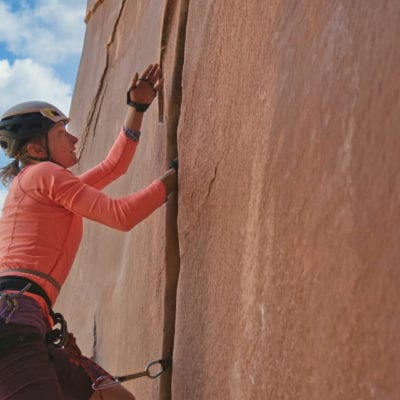 a women rock climbing in moab