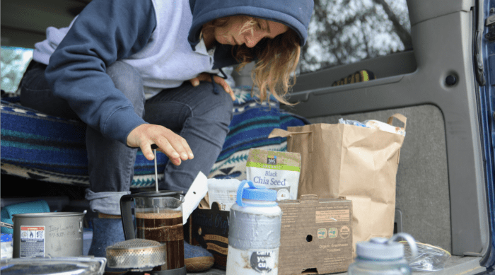 climber making coffee in the back of her car