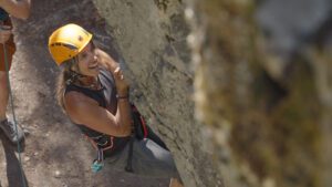 Female client rocking climbing in Whitefish, Montana.