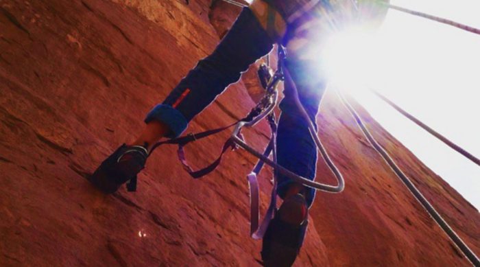 a climber repels during a big wall clinic