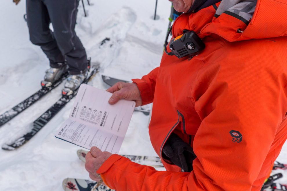 A mountain guide recording snow observations.