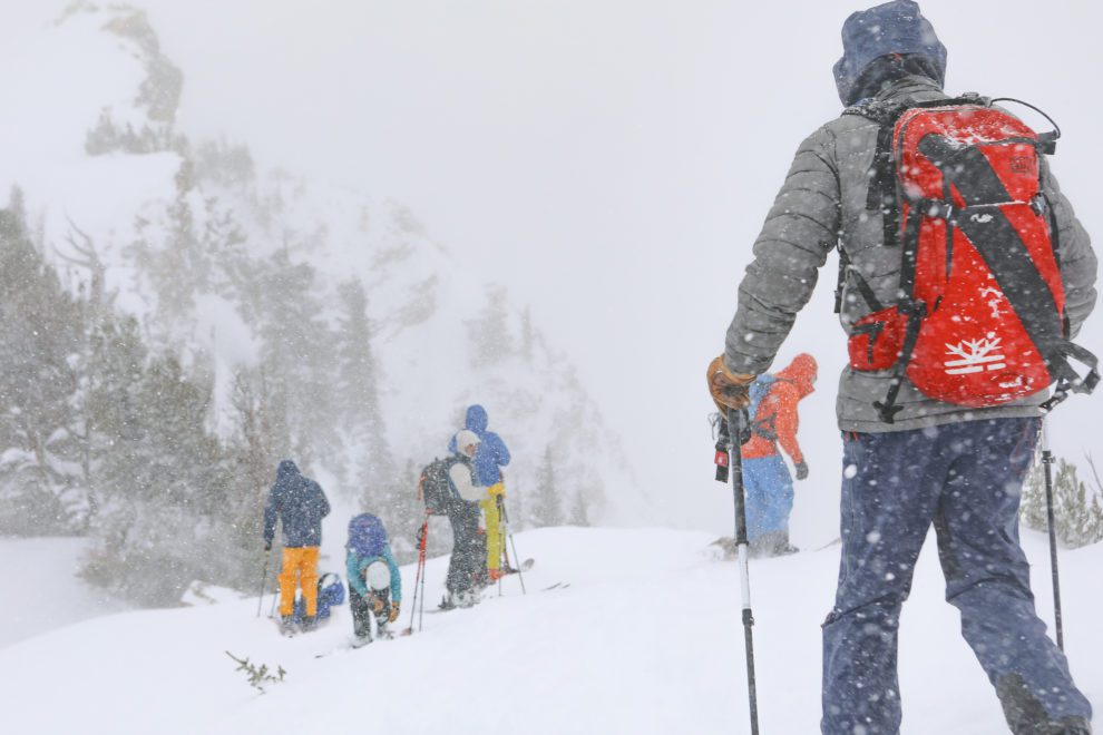 a group of backcountry skiers transitioning