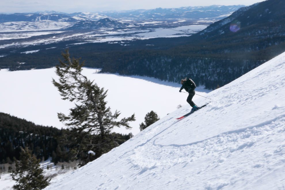 A backcountry skier descends in spring conditions.